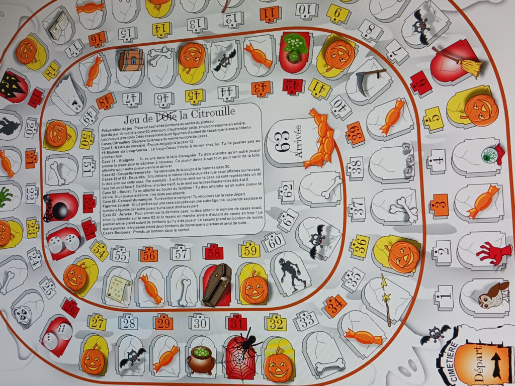 Plateau de jeu de l'oie coloré avec dés et pions en bois sur une table